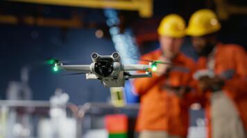 Professional drone operators flies a UAV around a drilling rig, using remote control and camera systems to evaluate the condition and ensure safety on platform, oil production. Camera B. video