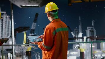 Industrial worker on offshore drilling rig evaluates data for emission tracking, tablet technology to manage efficient fossil fuels extraction from the maritime environment. Camera B. video