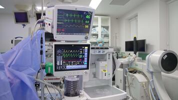 Advanced technological equipment switched on and working during operation. Numerous apparatuses involved in operation. Screens depicting patient's condition. Close up. video