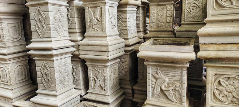 A collection of carved stone pillars. The detailed texture and craftsmanship highlight artistic cultural design often used in architecture or garden decoration. photo