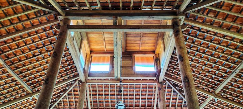 Open-air joglo-style architecture. Traditional Javanese wooden pavilion with a tiled roof. photo