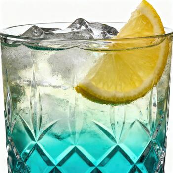 Frosted glass containing vibrant blue liquid, ice cubes, and a fresh citrus slice against a bright background photo