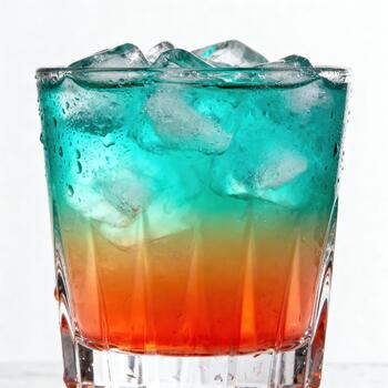 Vibrant layered cold beverage fills a textured glass with abundant ice cubes photo