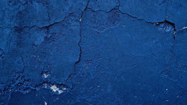 Deep indigo surface displays extensive textural imperfections and structural fractures photo