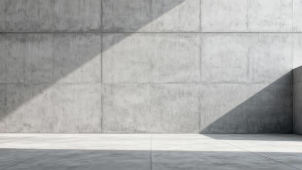 Stark minimalist interior space features raw concrete surfaces intersected by sharp geometric shadows photo