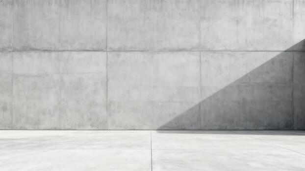 Stark geometric shadow cuts across a large, textured concrete wall and floor surface photo