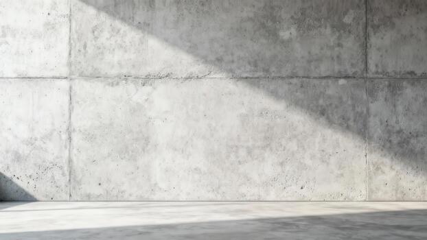Textured gray concrete wall surface displays diagonal sunlight illumination across a floor photo