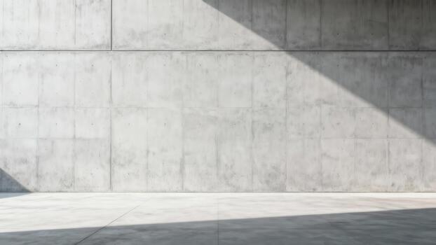 Bare concrete wall and floor surface illuminated by strong diagonal sunlight creating sharp shadows photo