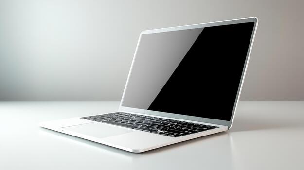A laptop computer with a blank screen on a white surface photo