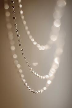 Silver beaded chain creating sparkling bokeh effect photo