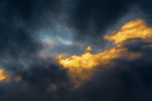 Thunderstorm clouds illuminated by disappearing rays at sunset and dark thunderclouds floating across sky to change weather photo