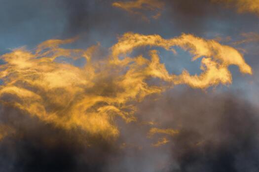 Fluffy thunderclouds illuminated disappearing rays at sunset floating across sky to change weather photo