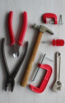 Set of reliable hand work tools on a wooden table. Tools used for a long time at work vertical stock photo