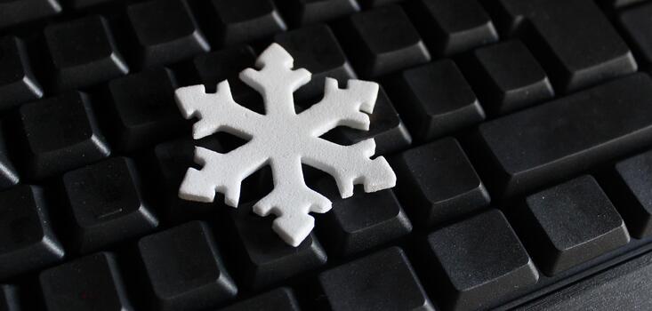 Conceptual Design with Snowflake Figurine on Empty Buttons of Black Keyboard. Blank Keys with Winter Sign on It photo