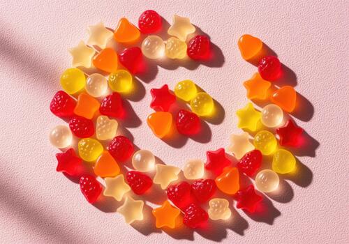 Brightly colored fruit flavored gummy vitamins in a playful swirl pattern photo