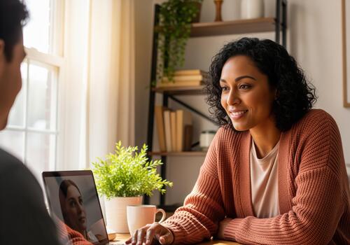 Smiling woman engaging in a virtual meeting with a client at home photo
