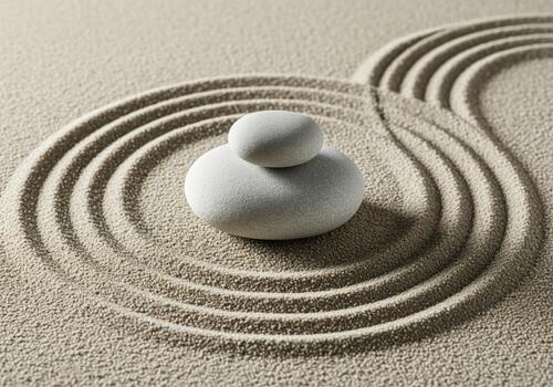 Stacked smooth grey stones in a tranquil zen garden with raked sand patterns photo