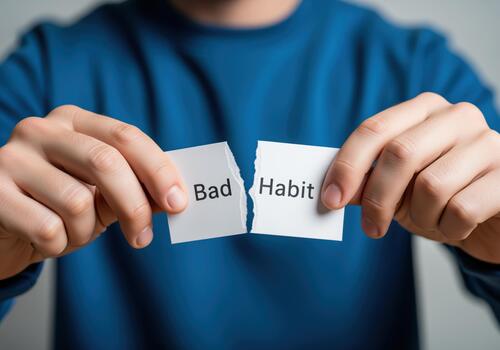 Breaking a bad habit, hands ripping paper with bad habit text, representing personal growth. photo
