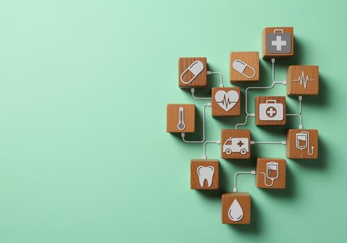Interconnected healthcare and medical icons forming a network on wooden blocks photo