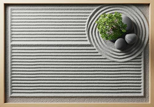 Overhead view of a serene miniature zen garden with raked sand, stones, and a small green tree photo