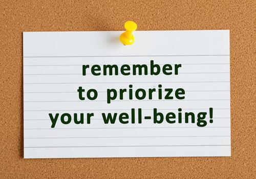 Prioritize your well being reminder on lined index card with thumbtack photo
