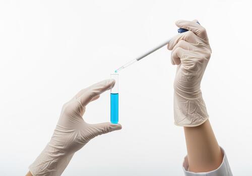Science experiment gloved hands with test tube and dropper in laboratory photo