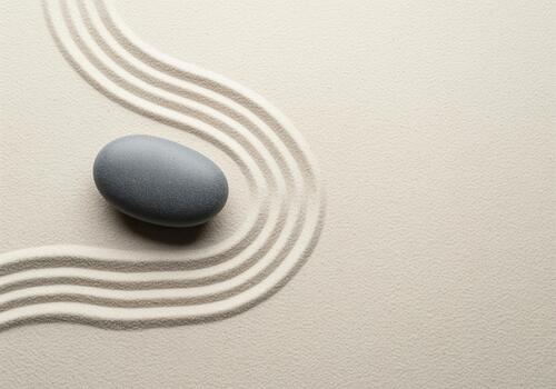 Zen garden serenity with smooth grey stone and raked sand pattern photo