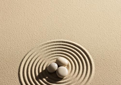 Serene zen garden with three balanced stones and concentric sand ripples photo