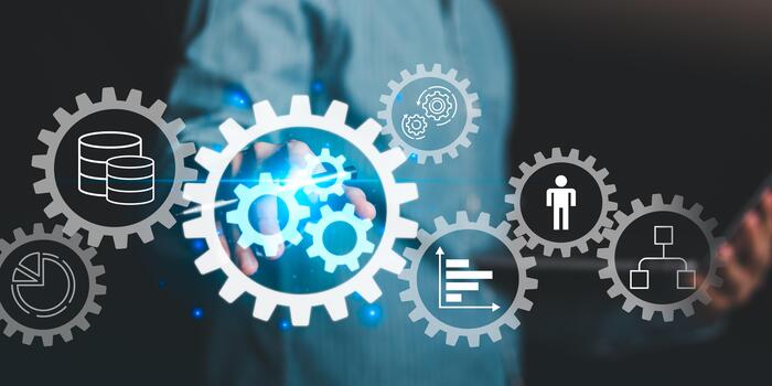 A businessman interacting with virtual gear icons representing automation, workflow, data management, and corporate efficiency in digital business technology and process improvement systems. photo