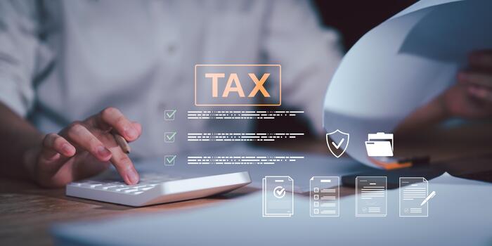 Businessman calculating tax documents using digital checklist, representing financial audit, tax management system, compliance verification, and secure online accounting process for modern business. photo