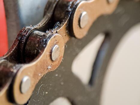 Macro view captures the intricate details of a bicycle chain, showcasing its design and mechanism. photo
