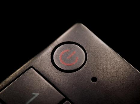 Textured surface shows an power symbol button, hinting at control and technological operation. photo