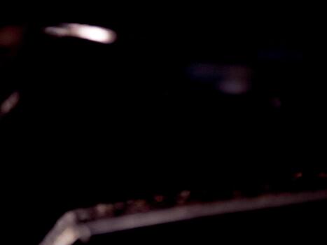 Abstract dark image featuring blurry shapes and a mysterious, moody atmosphere with diffused light. photo