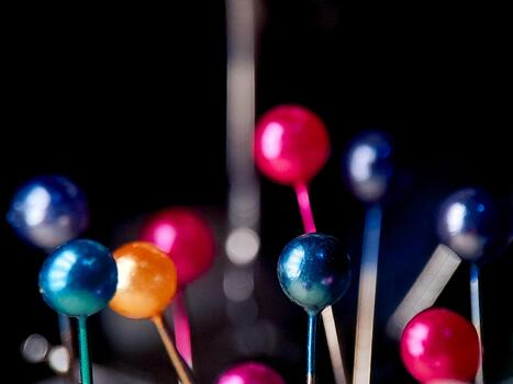 Vibrant array of colorful round-headed pins create a whimsical and playful composition. photo