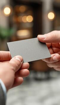 Hands exchanging blank business card for networking contact photo
