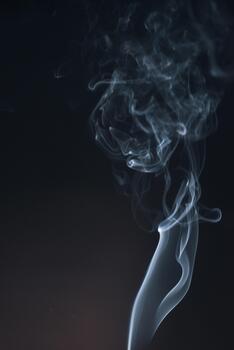 Ethereal Smoke Swirls Against Dark Background Creating Mystical and Abstract Patterns in Motion photo