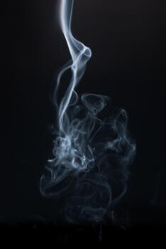 Ethereal Smoke Swirls Against Dark Background Creating Abstract and Mystical Patterns in Motion photo