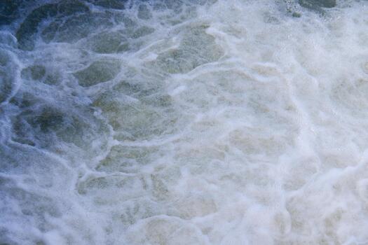 Dynamic Ocean Waves Crashing and Creating White Foam Patterns in a Powerful Natural Seascape photo