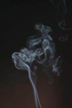 Ethereal Swirls of Smoke Against a Dark Background Capturing Mystical and Abstract Patterns in Motion photo