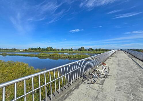 Wooden fence lines the path, guiding the viewer's eye towards the summit of the hill, creating a sense of journey and exploration photo