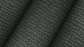 Matte black rolls rotating cleanly with embossed grid texture presented inside a unique softly lit abstract background video