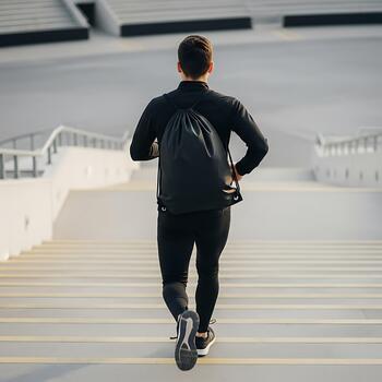 Man Running On Concrete Steps With Empty Back Sack photo