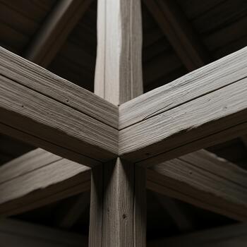 Intricate wooden beam structure with a symmetrical geometric pattern creating a sense of depth and architectural detail photo