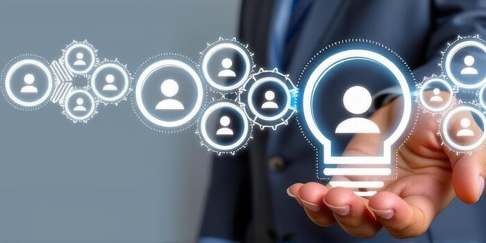 Person suit holds digital representation of light bulb with user icons, symbolizing innovative networking and human resources management. image conveys sense of modern technology and connectivity photo