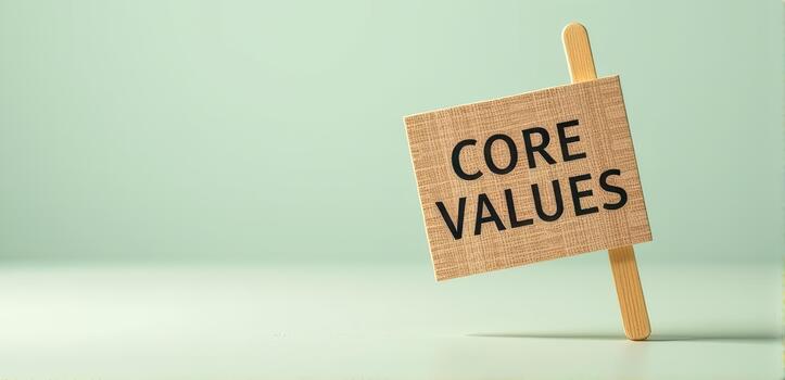 Small wooden sign with words CORE VALUES stands against soft green background, symbolizing principles and beliefs. minimalist design conveys sense of clarity and focus photo