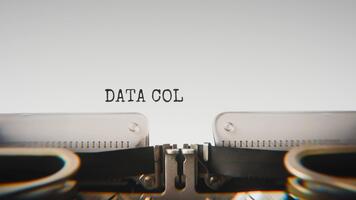 Old mechanical typewriter typing Data Collection in a close up view, with metal letters striking the white paper. video