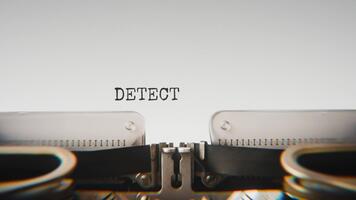 Old mechanical typewriter typing Detection in a close up view, with metal letters striking the white paper. video