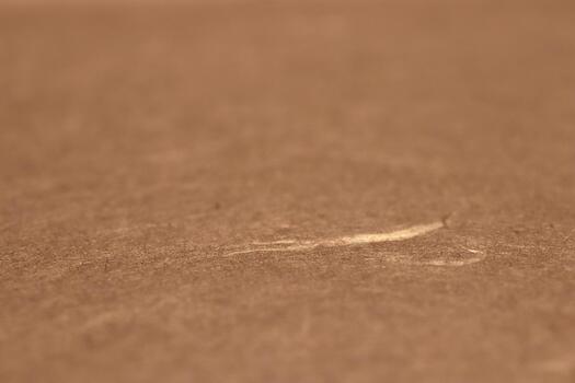 Close-up of a scratch on a brown paper texture surface. photo