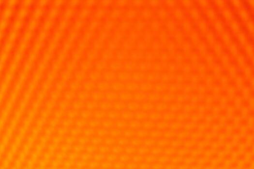 Orange yellow vibrant abstract background. The blurred geometric hexagonal pattern creates a warm, intense, and dynamic texture photo