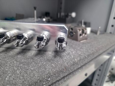 Precision engineering a series of metal components displayed on a textured work surface photo